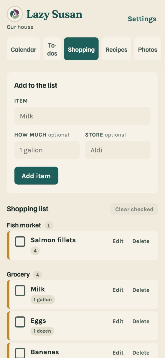 The shopping list on a phone, grouped by store.